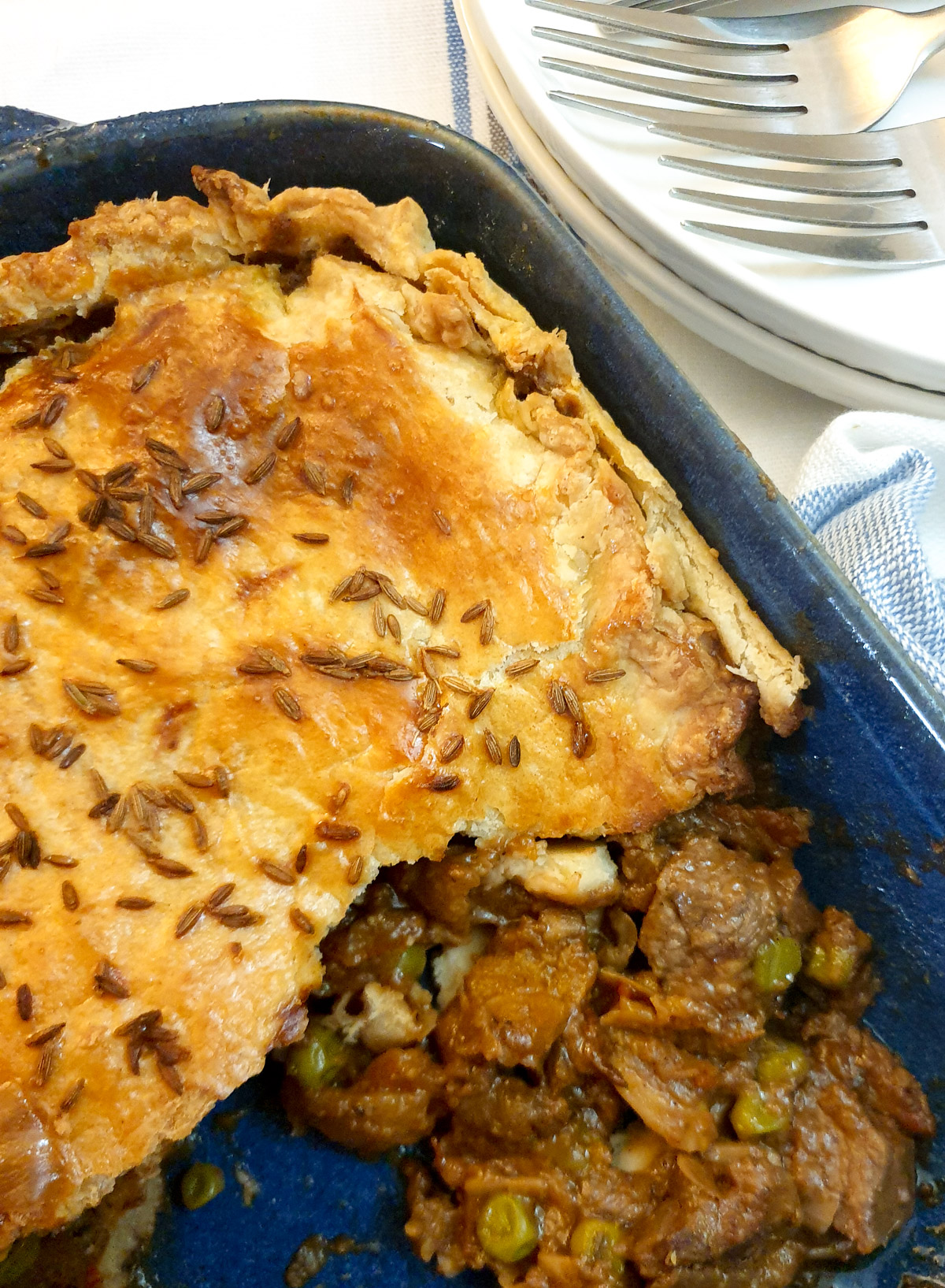 A Moroccan lamb pie with part of the crust removed to reveal the filling.