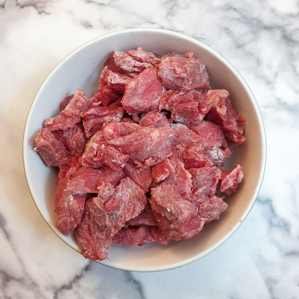 A dish of pieces of beef coated with flour.