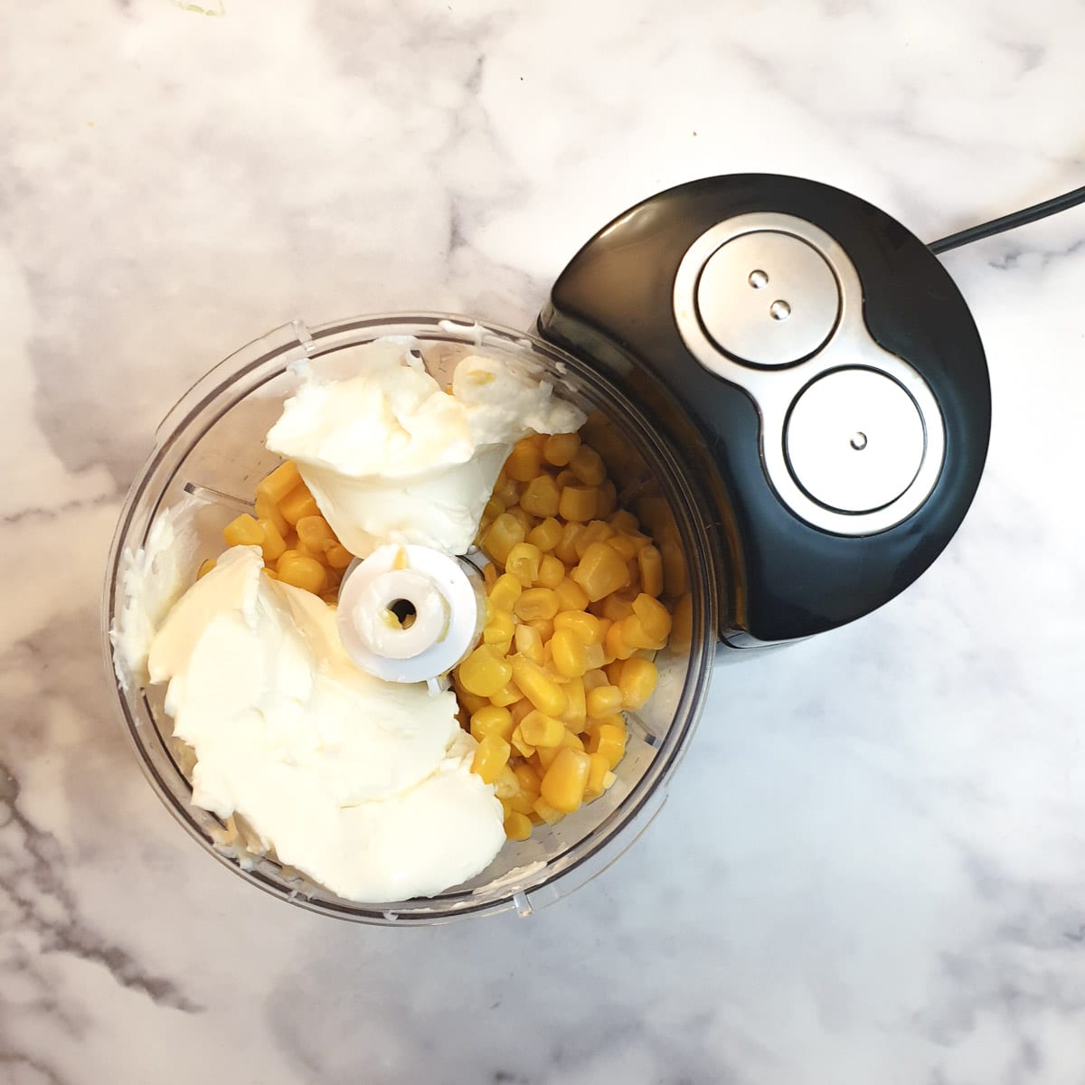 Sweetcorn kernels and cream cheese in a small food processor.