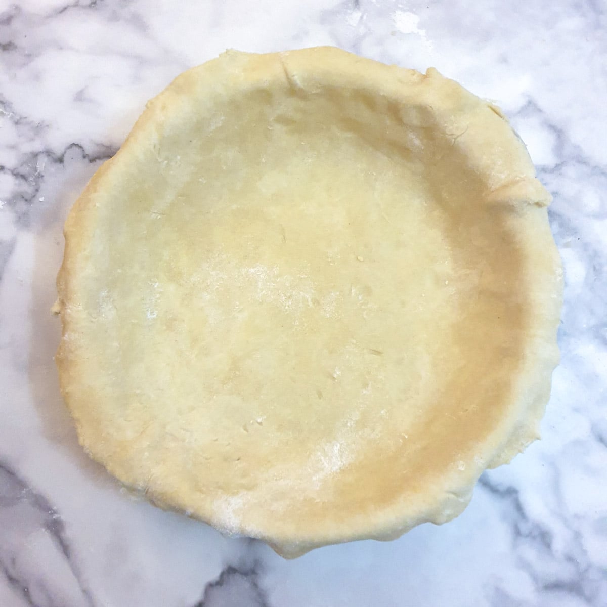 A baking dish lined with pastry.