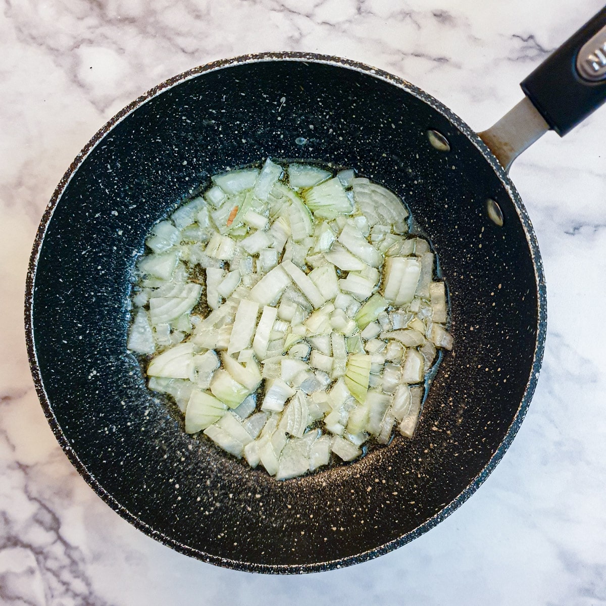 Chopped onions being sauteed in butter.