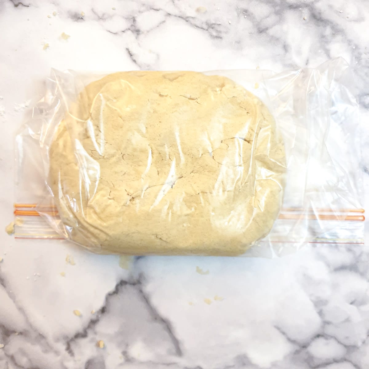 Pastry in a plastic bag on a work surface.