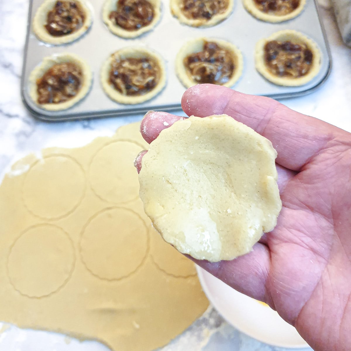 Closeup of the underside of a pastry lid brushed with egg-wash.