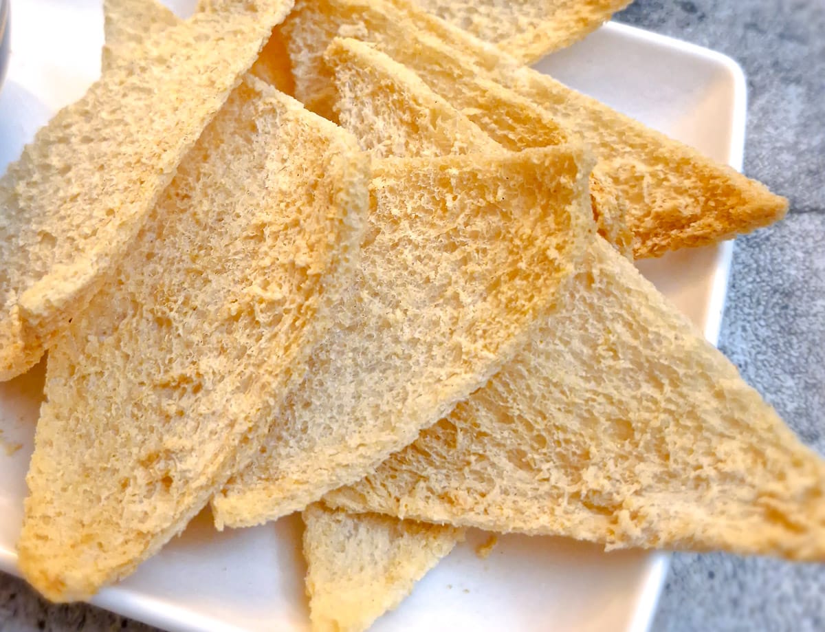 Close up of melba toast triangles.