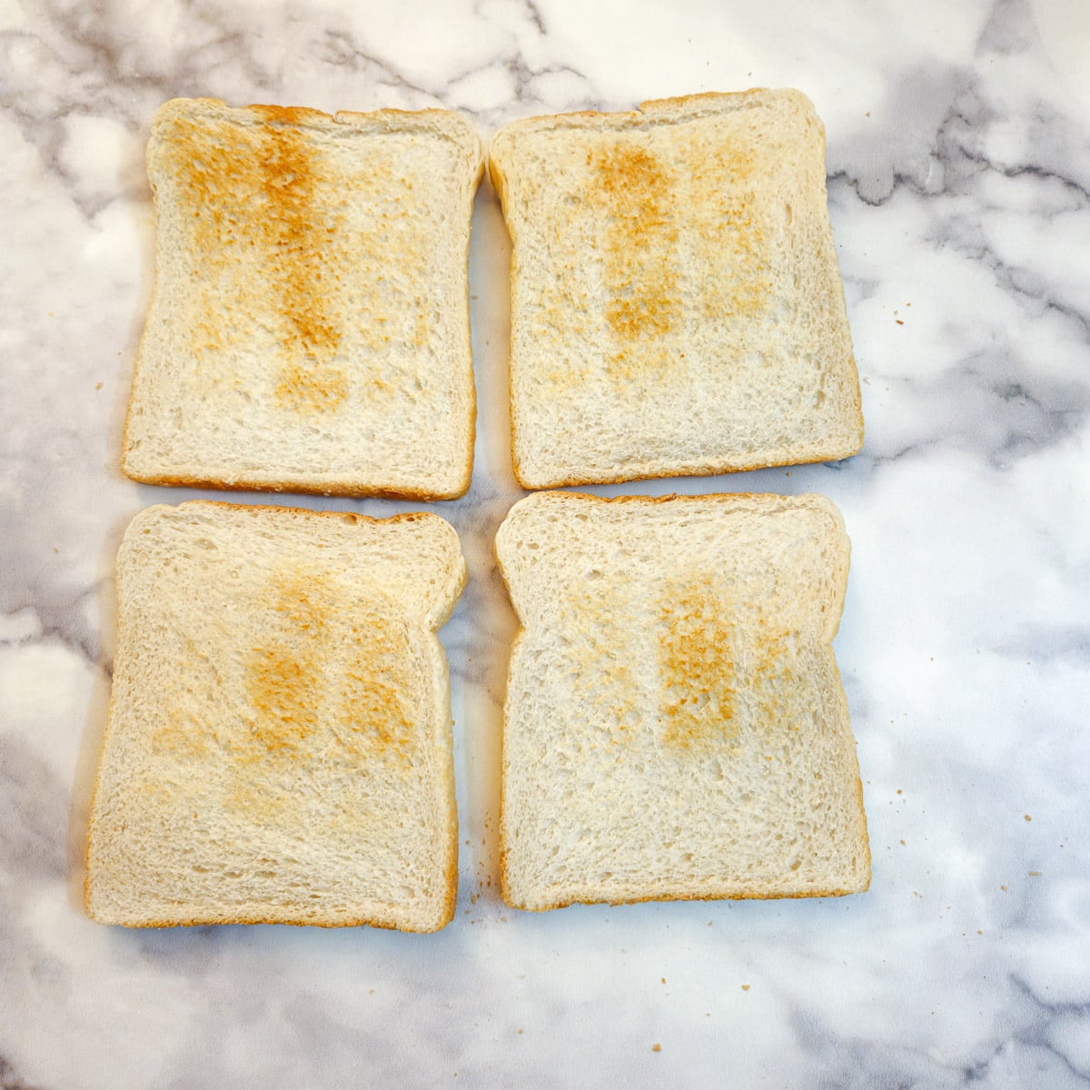 Four slices of lightly toasted white bread.