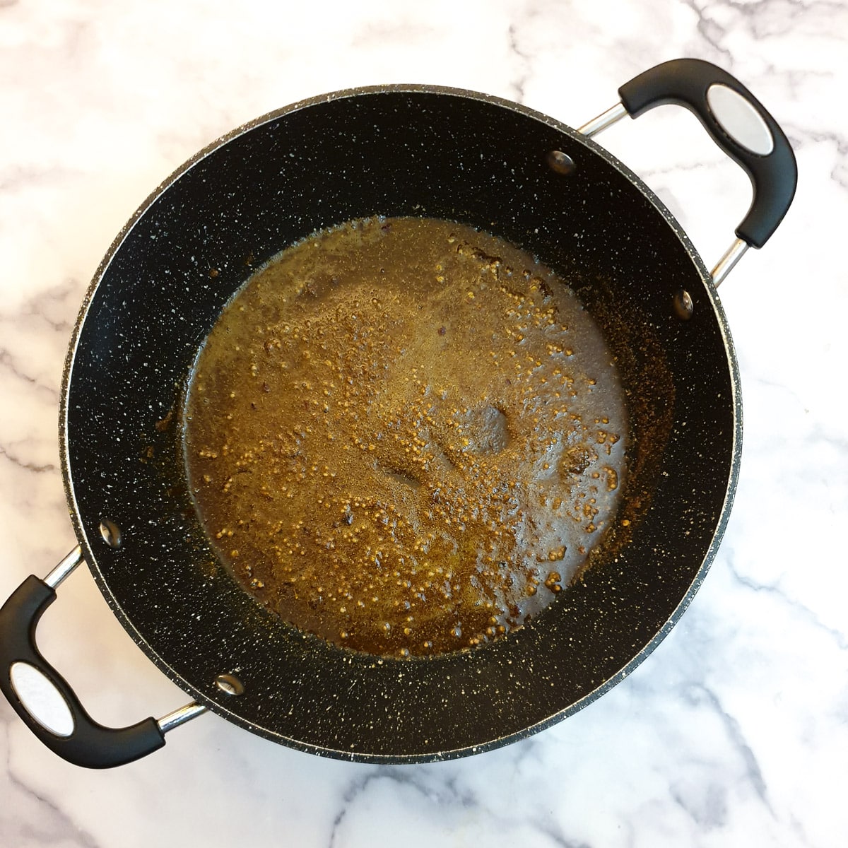 Spices frying in a frying pan.