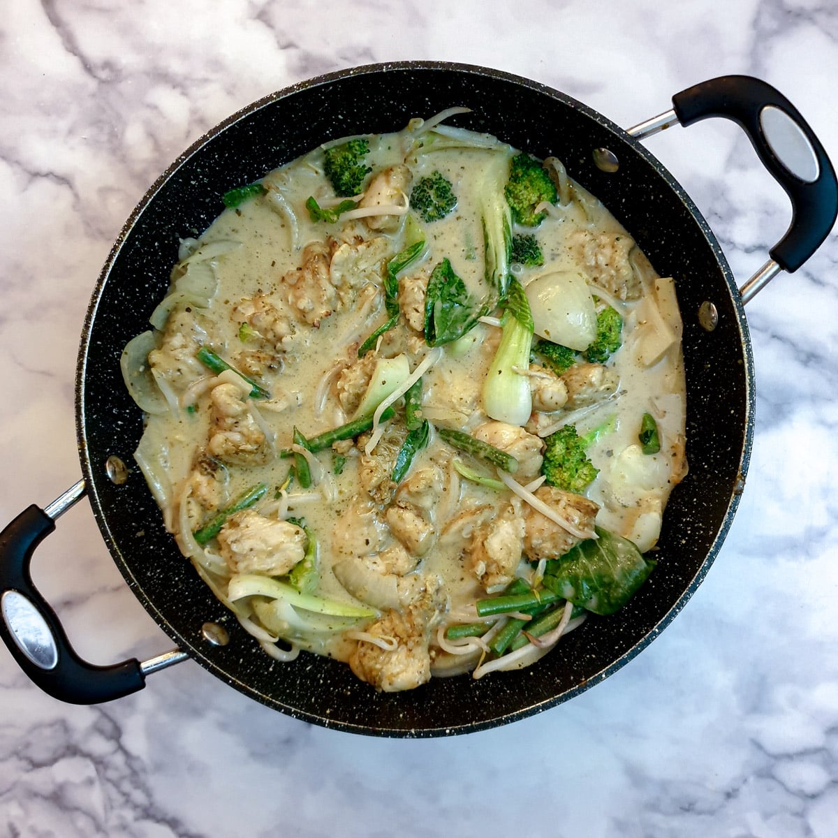 Chicken returned to the pan and mixed into the Thai sauce.