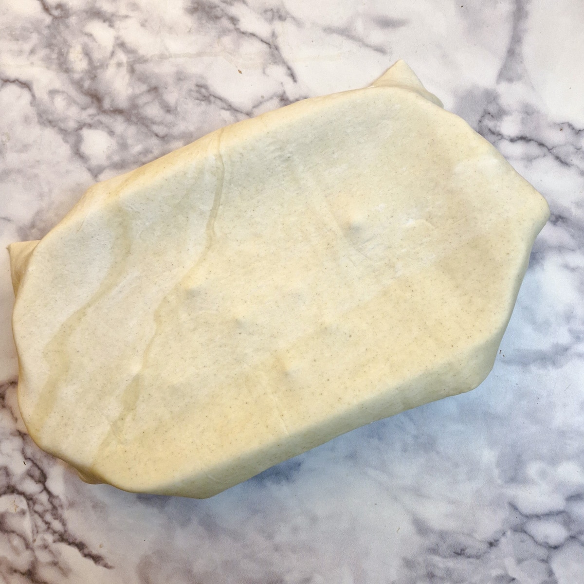 A sheet of puff pastry placed over the casserole dish.