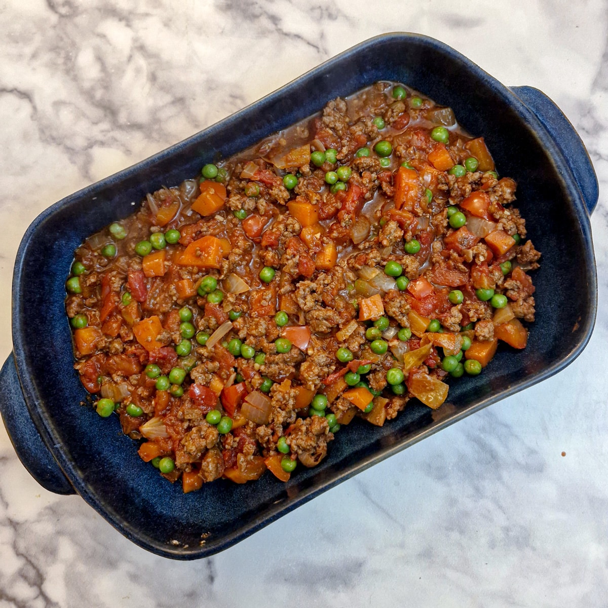 Beef keema in a baking dish before the rosti topping is added.