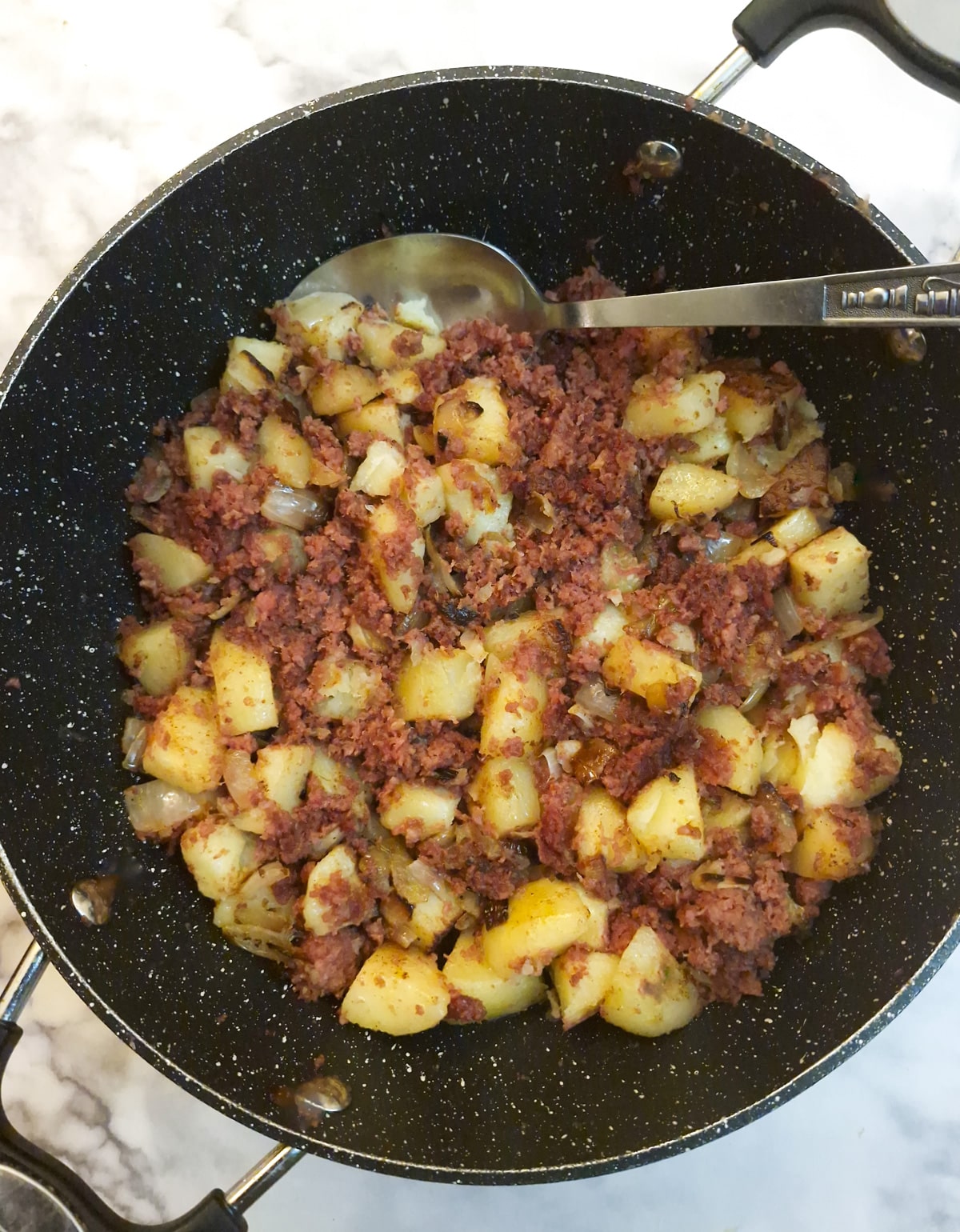 Corned beef hash in a frying pan.