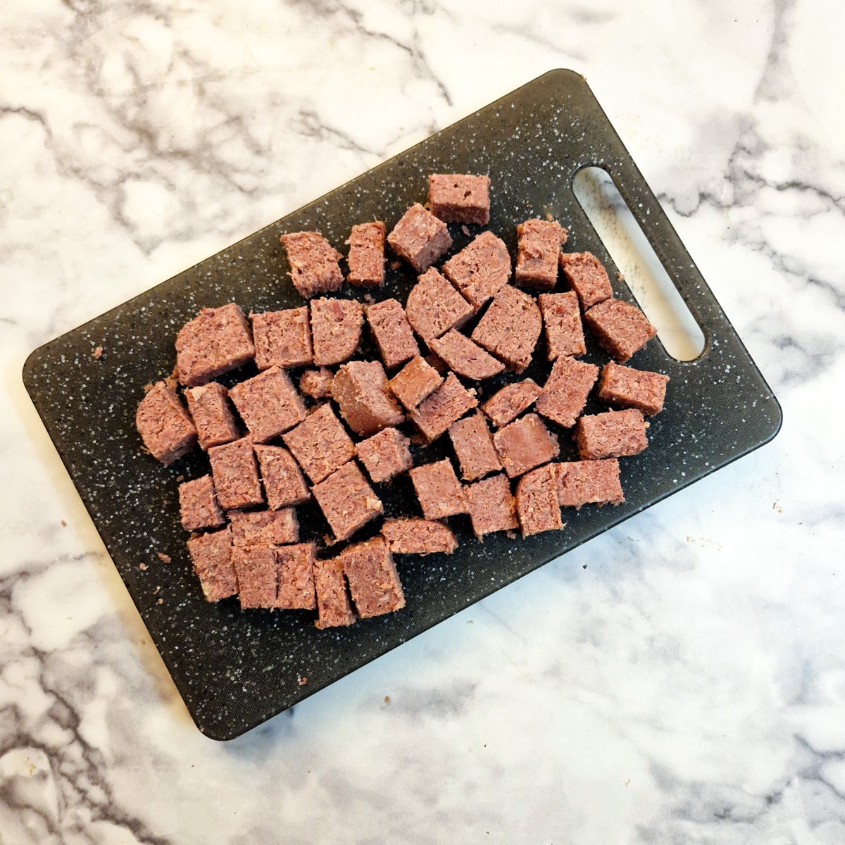Pieces of corned beef on a chopping board.