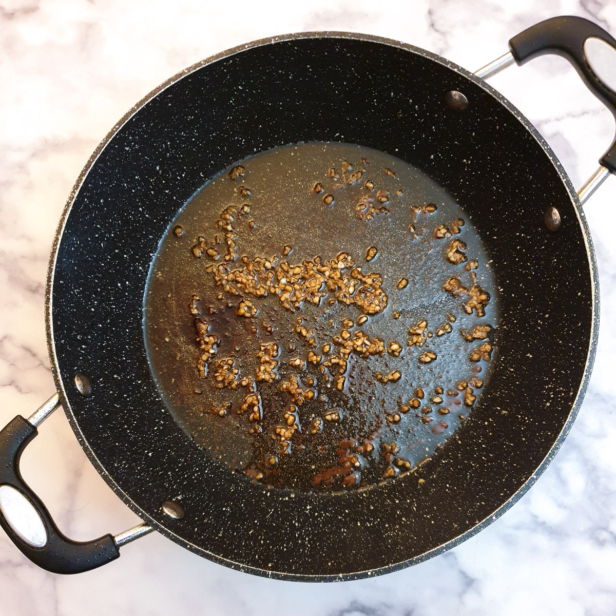 Minced garlic in a frying pan.