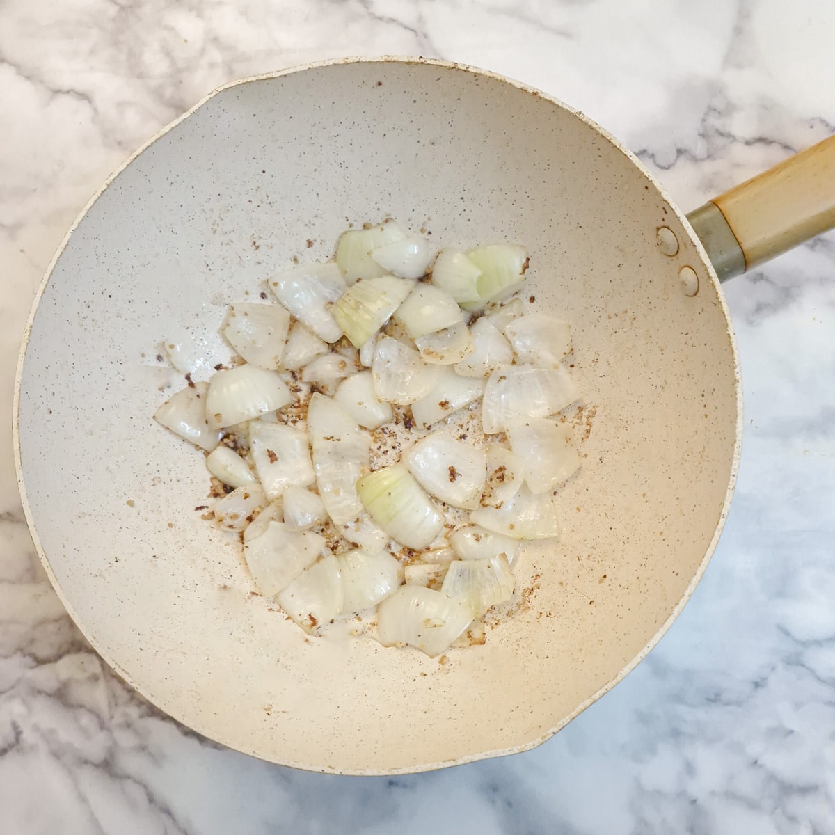 Onions frying in a wok.