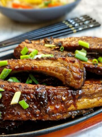 Close up of pork spareribs on a plate.