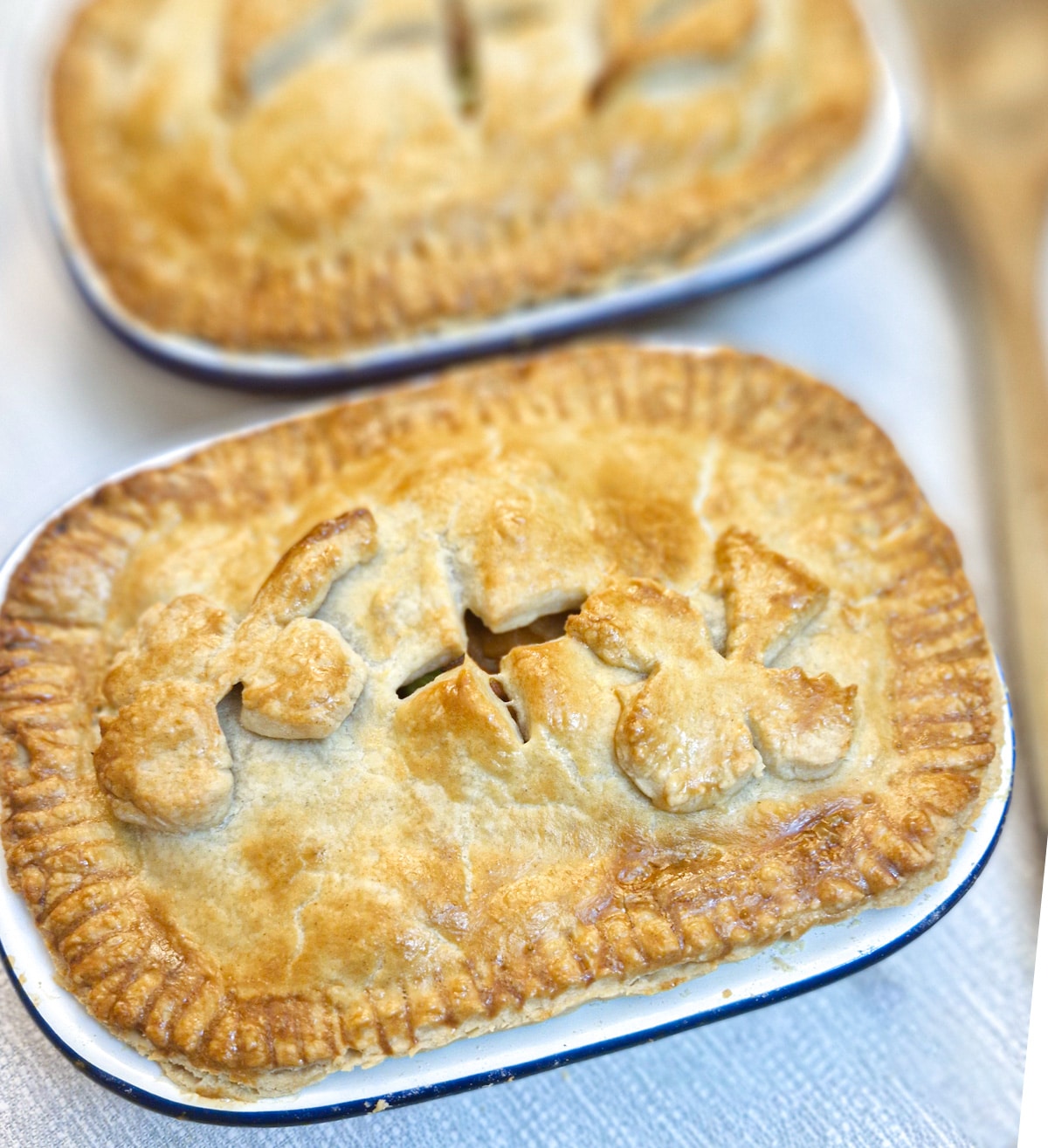 Close up of a corned beef and potato pie, with a second pie in the background.