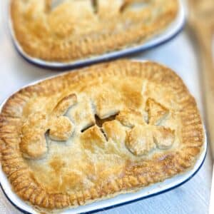 Close up of a corned beef and potato pie, with a second pie in the background.