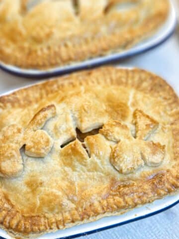 Close up of a corned beef and potato pie, with a second pie in the background.