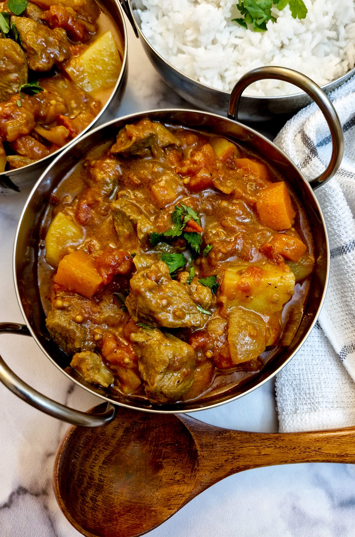 Overhead shot of lamb curry in a balti dish.