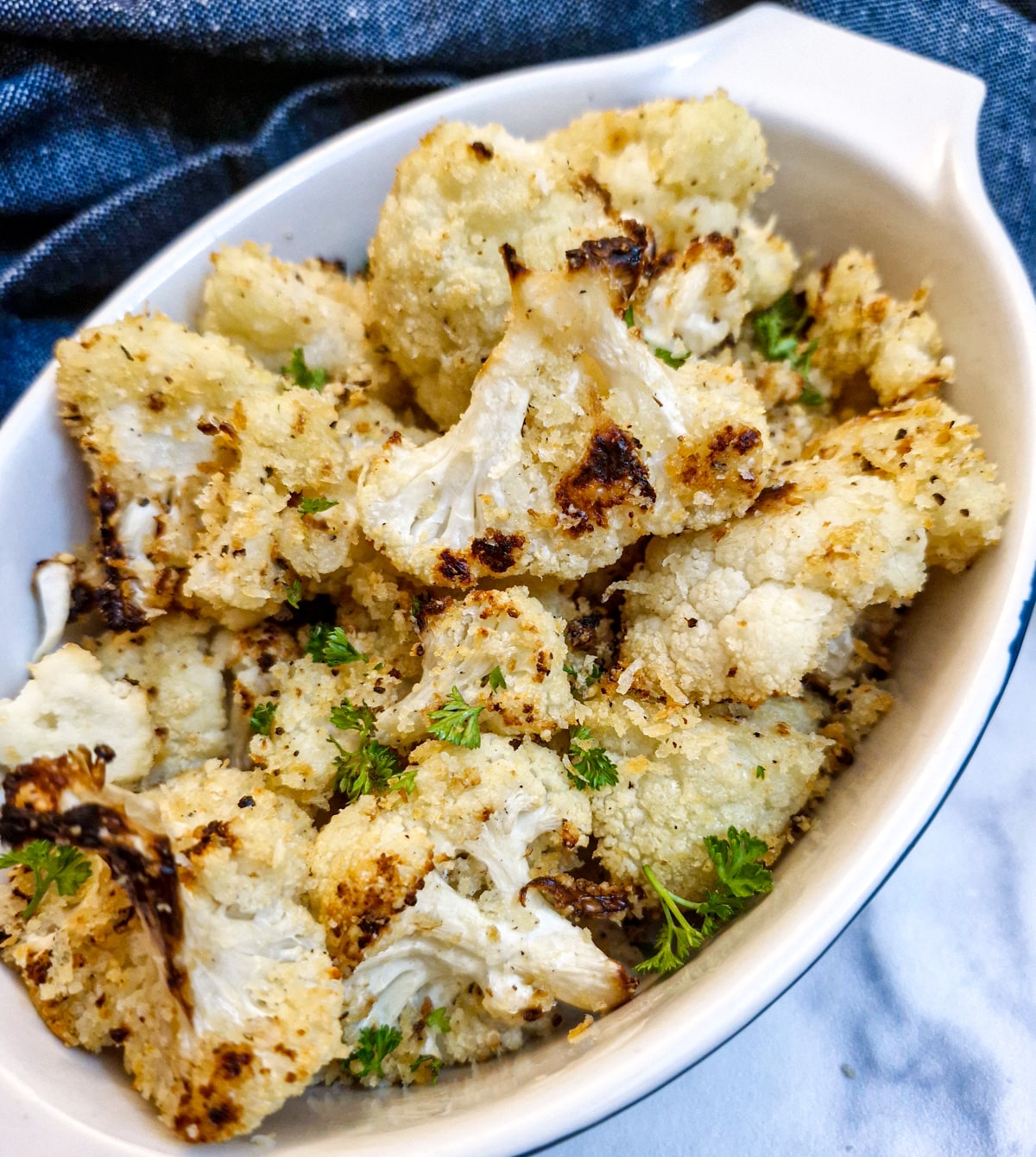 A dish of lightly browned parmesan roasted cauliflower.