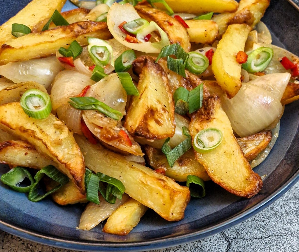 Close up of a dish of salt and pepper chips.