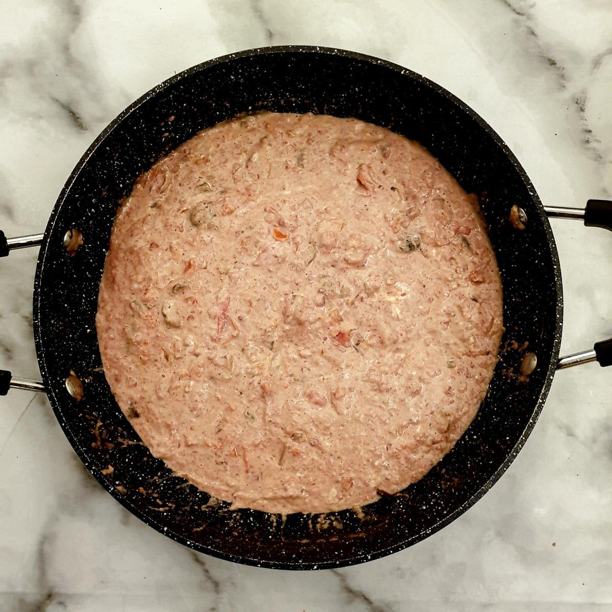 The bully beef pasta sauce after the addition of a tub of cream cheese.