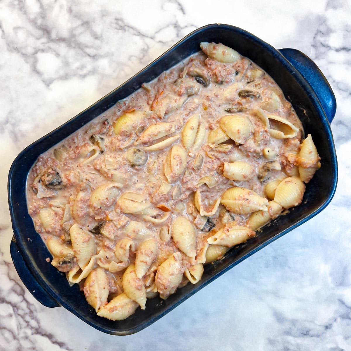 A baking dish filled with bully beef pasta and sauce.