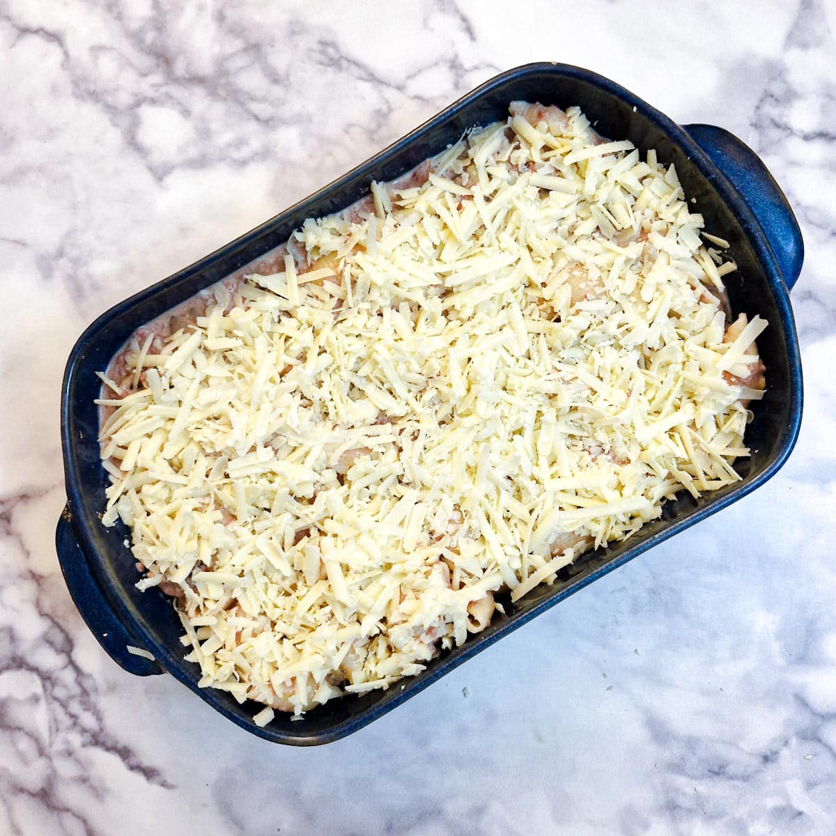 Grated cheese sprinkled on top of the bully beef pasta.