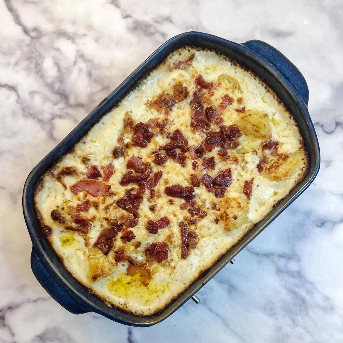 A baked dish of cheesy potato casserole.