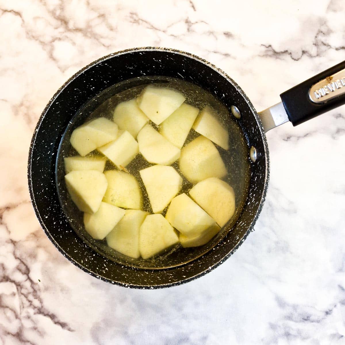 Potatoes in a saucepan of water.