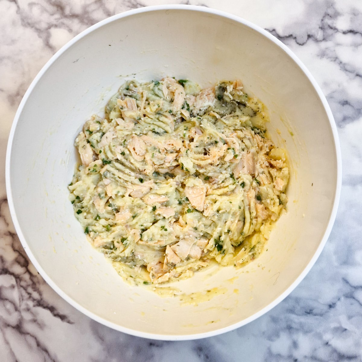 Salmon fishcake ingredients combined in a mixing bowl.