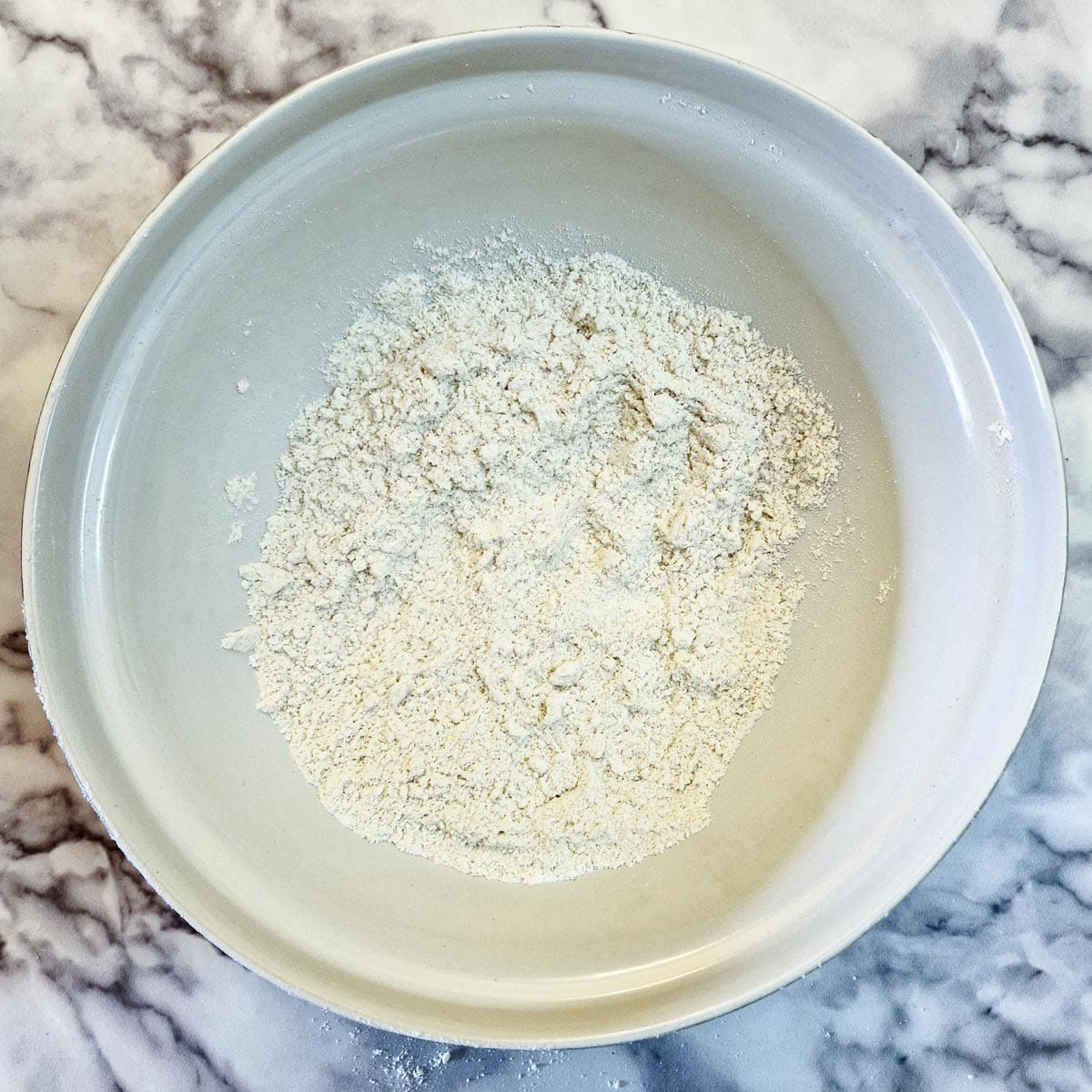 Butter rubbed into flour to form 'breadcrumbs'.