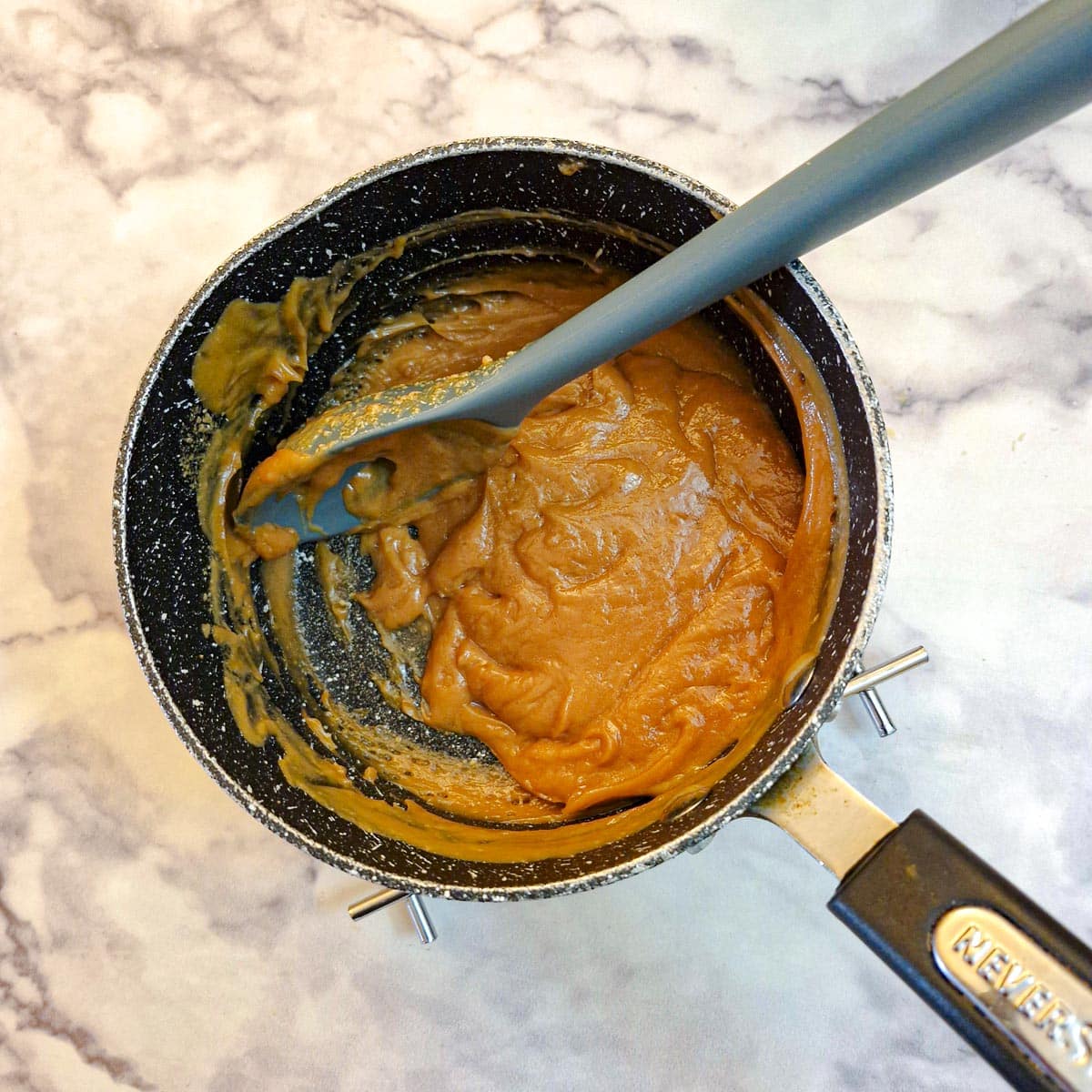 Peanut butter and honey heated in a saucepan to form a sticky toffee.