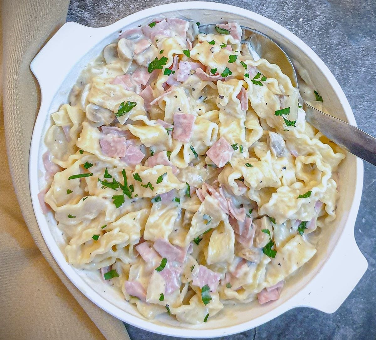 Overhead shot of a dish of ham and mushroom tagliatelle.