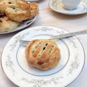 An Ecles cake on a small patterned plate.