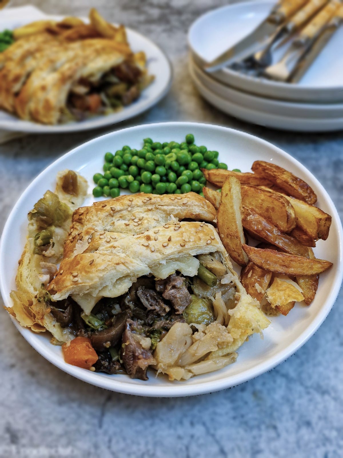 Close up of a slice of leftover lamb pie on a plate showing the filling.