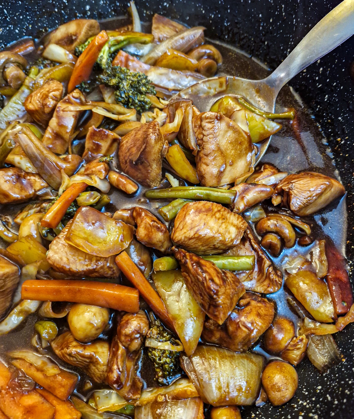 Closeup of a pan of Szechuan chicken and vegetables.