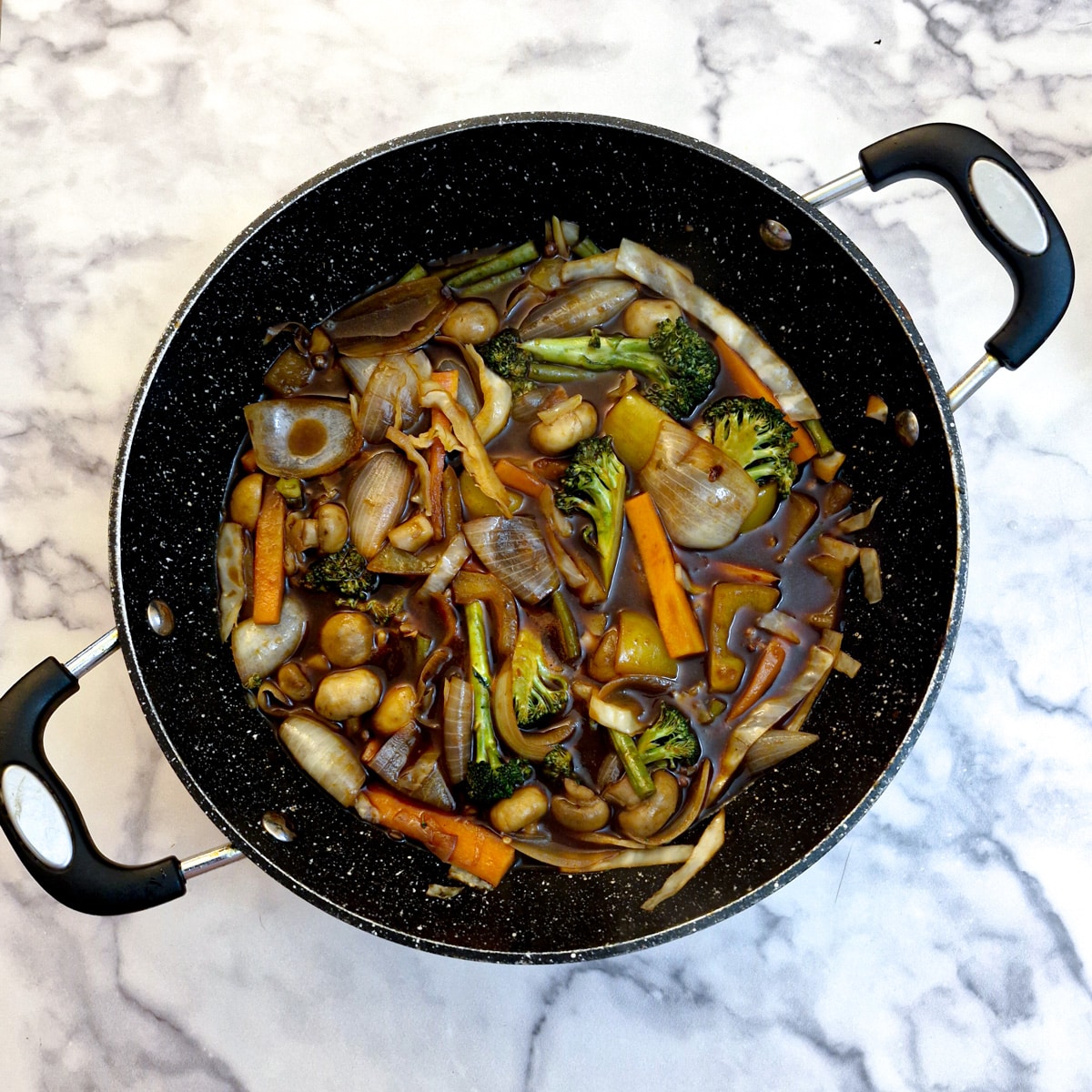 Sauce in the frying pan with vegetables.