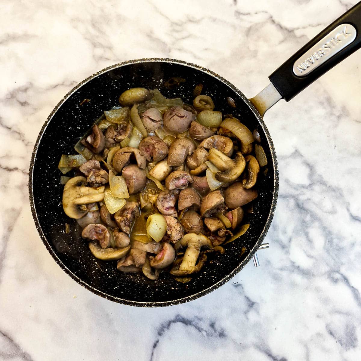 Frying lamb kidneys with the onions and mushrooms.