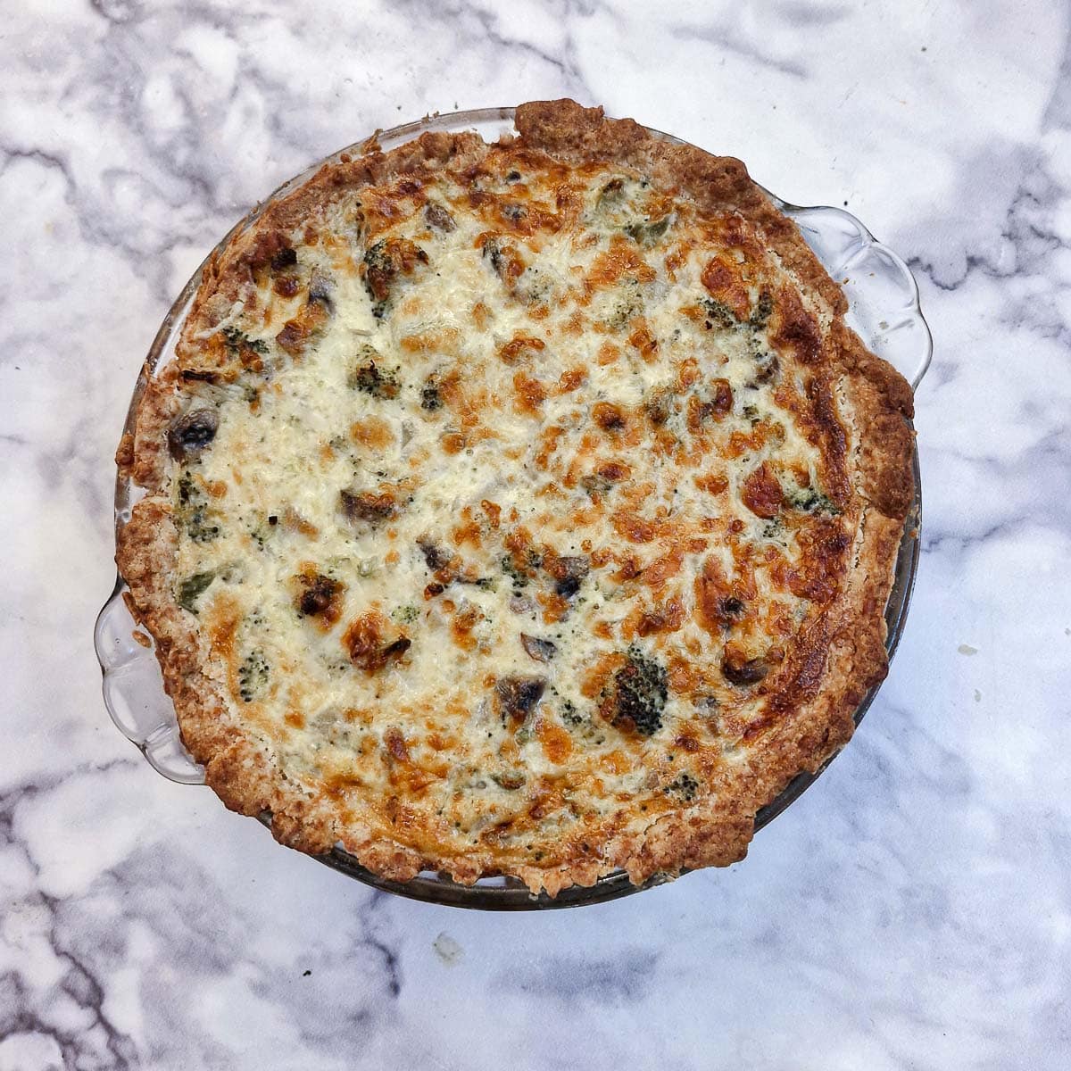 A baked cheese and broccoli quiche.