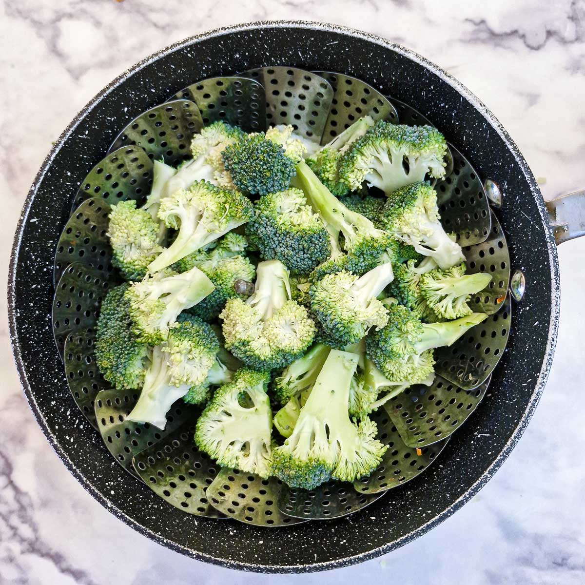 Broccoli florets in a steamer.