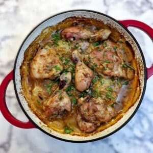 Overhead shot of a French onion chicken casserole in a red casserole dish.