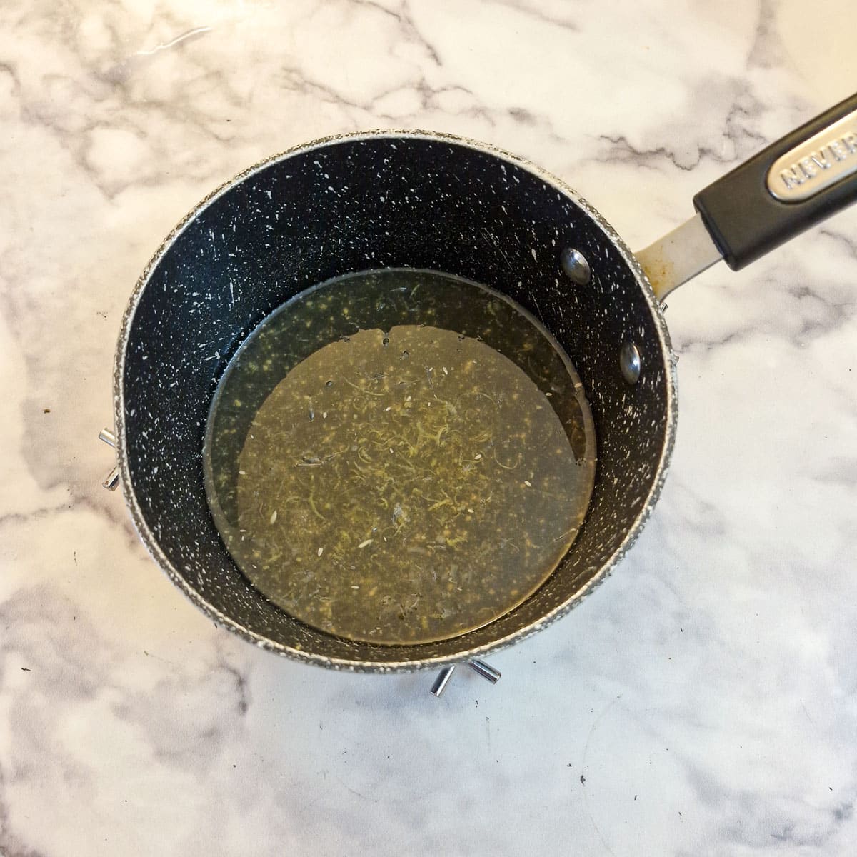 Honey and lemon juice in a saucepan.