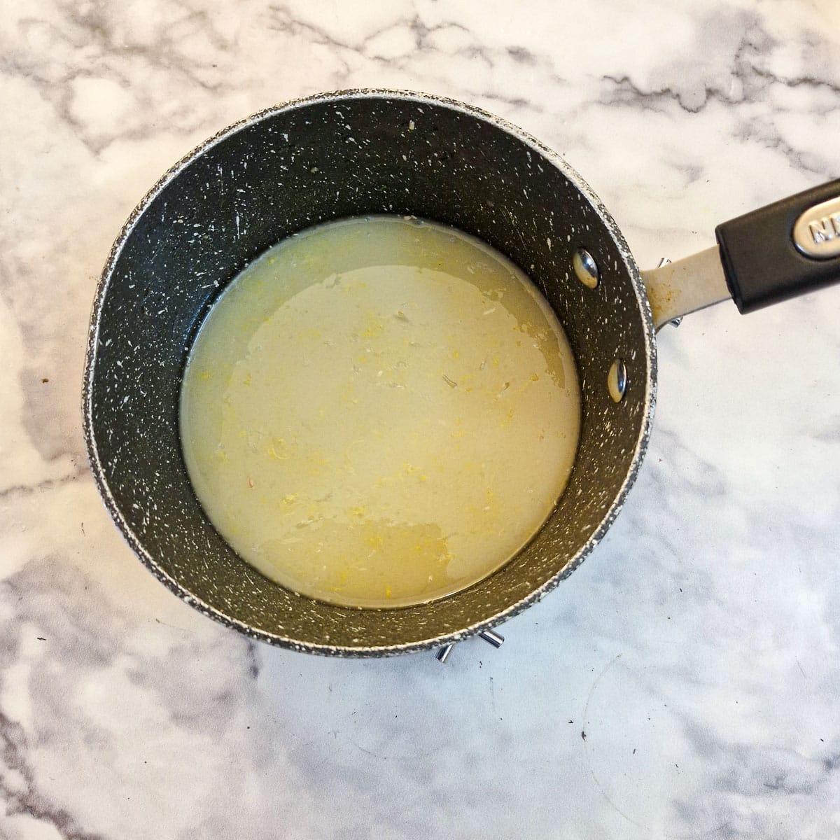 Cornflour and water addd to honey in a saucepan.