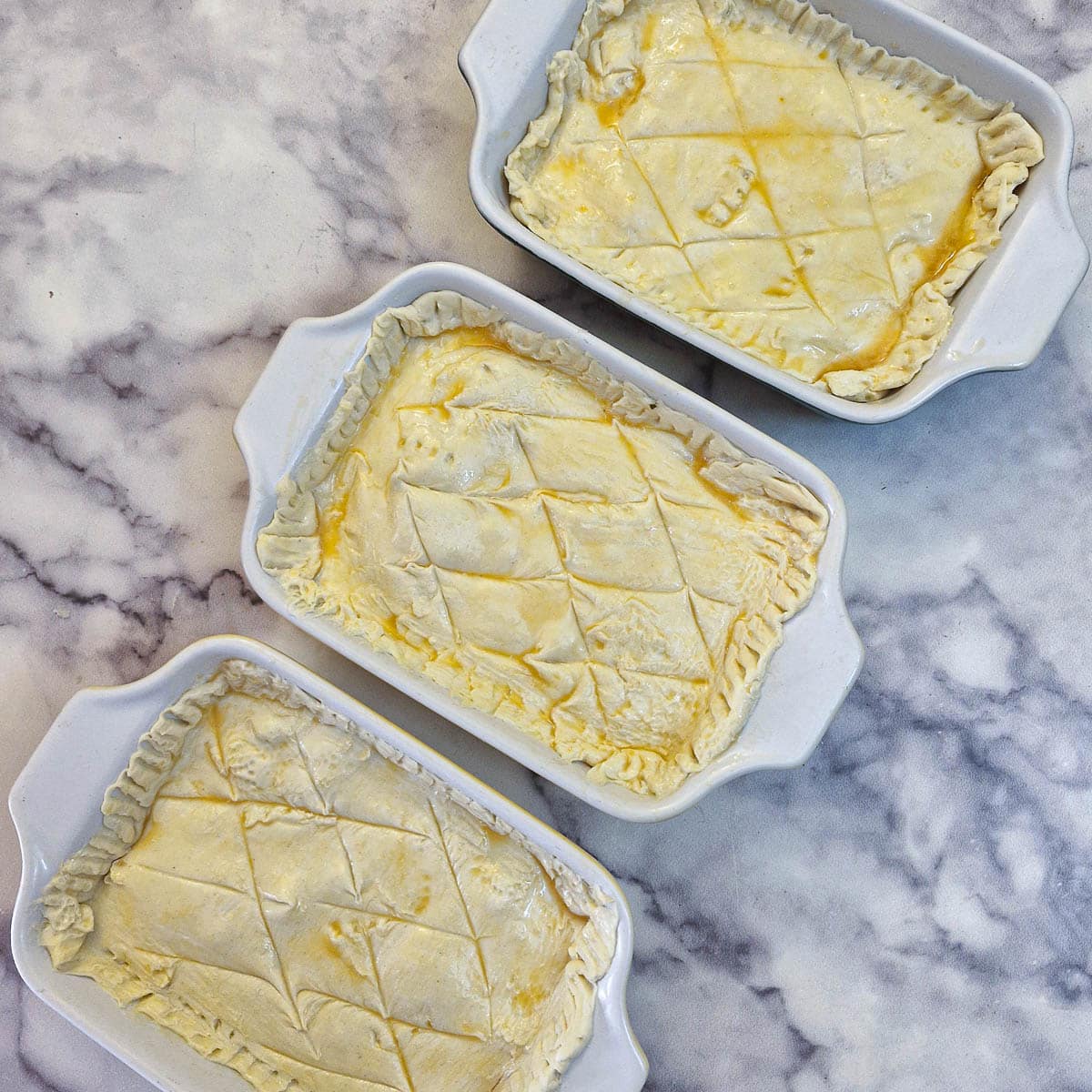 3 fully assembled chicken and mushroom pies.
