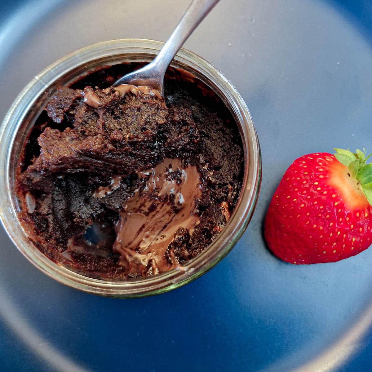 Close up of a microwave chocolate pot pudding showing the gooey inside.