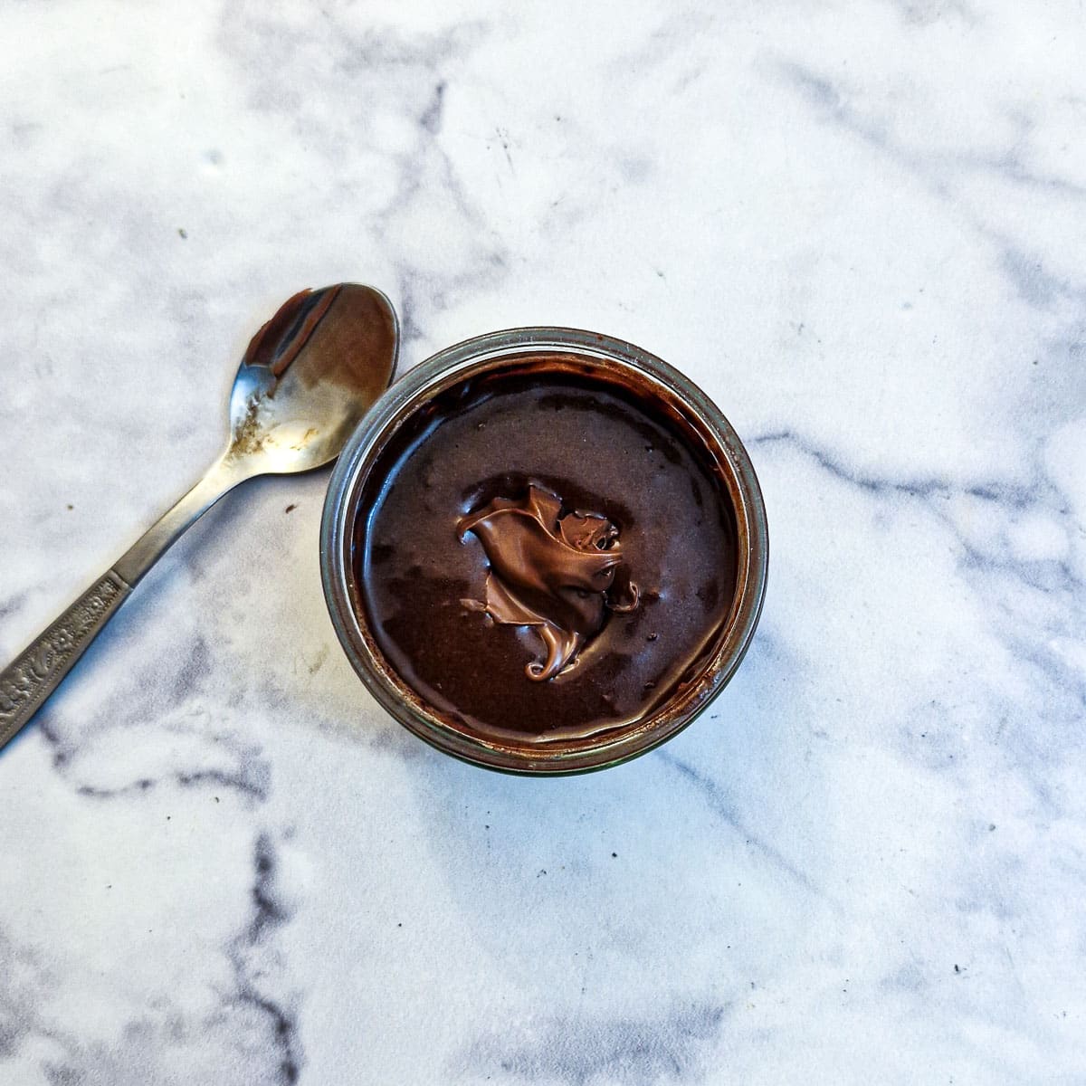 A teaspoon of Nutella in the centre of the chocolate pudding batter.