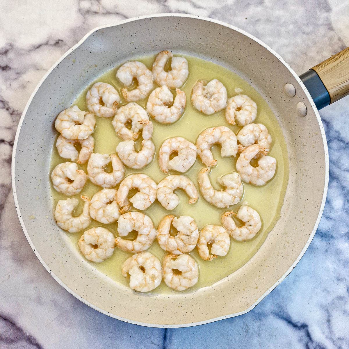 Cooked shrimp in a frying pan.