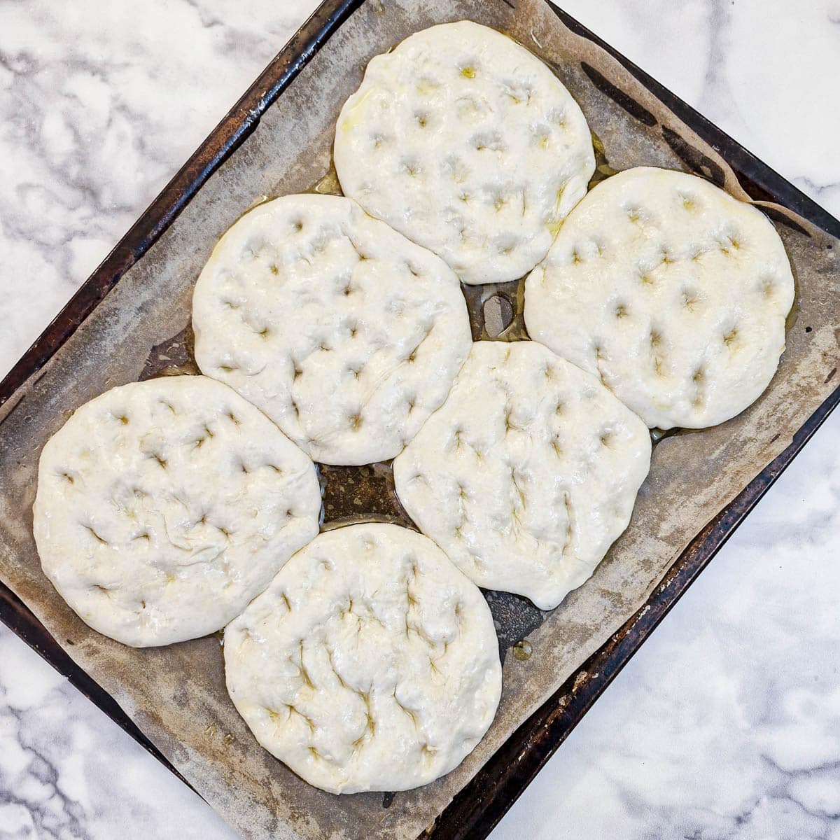 6 bread rolls brushed with olive oil and pressed to form indentations.