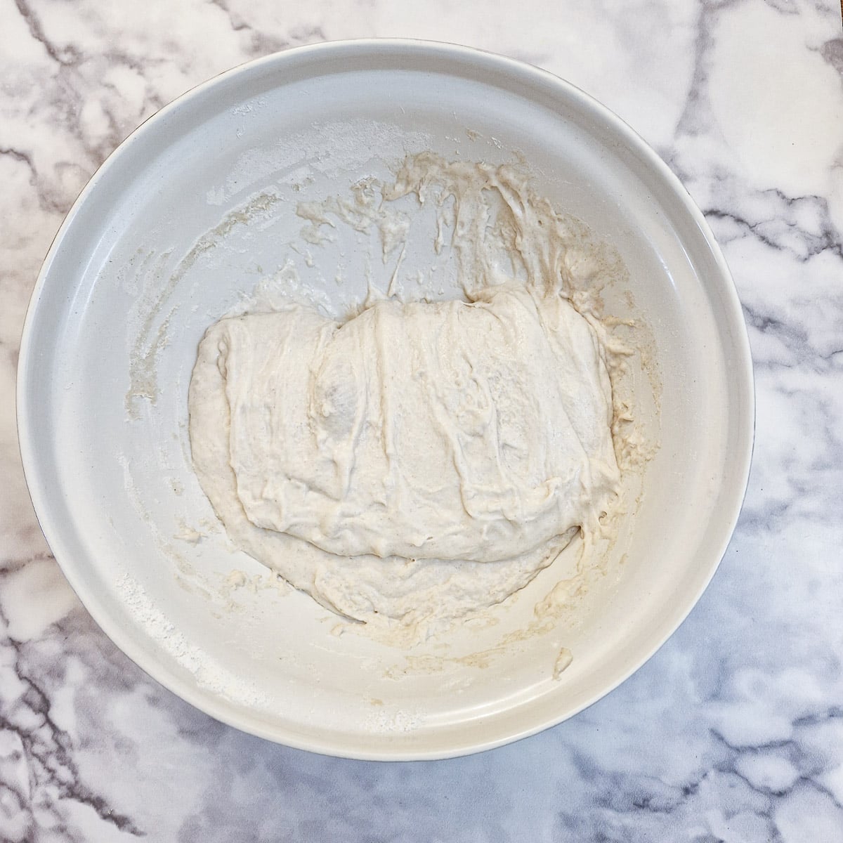 Dough being folded on itself.