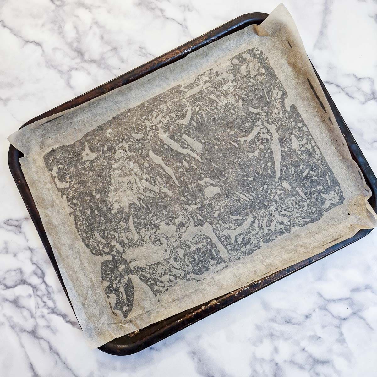 A baking sheet brushed with oil and lined with baking parchment.